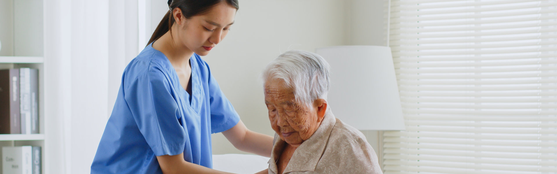 Caregiver assisting her elderly patient